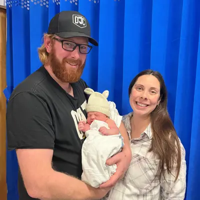 Man and woman holding newborn baby