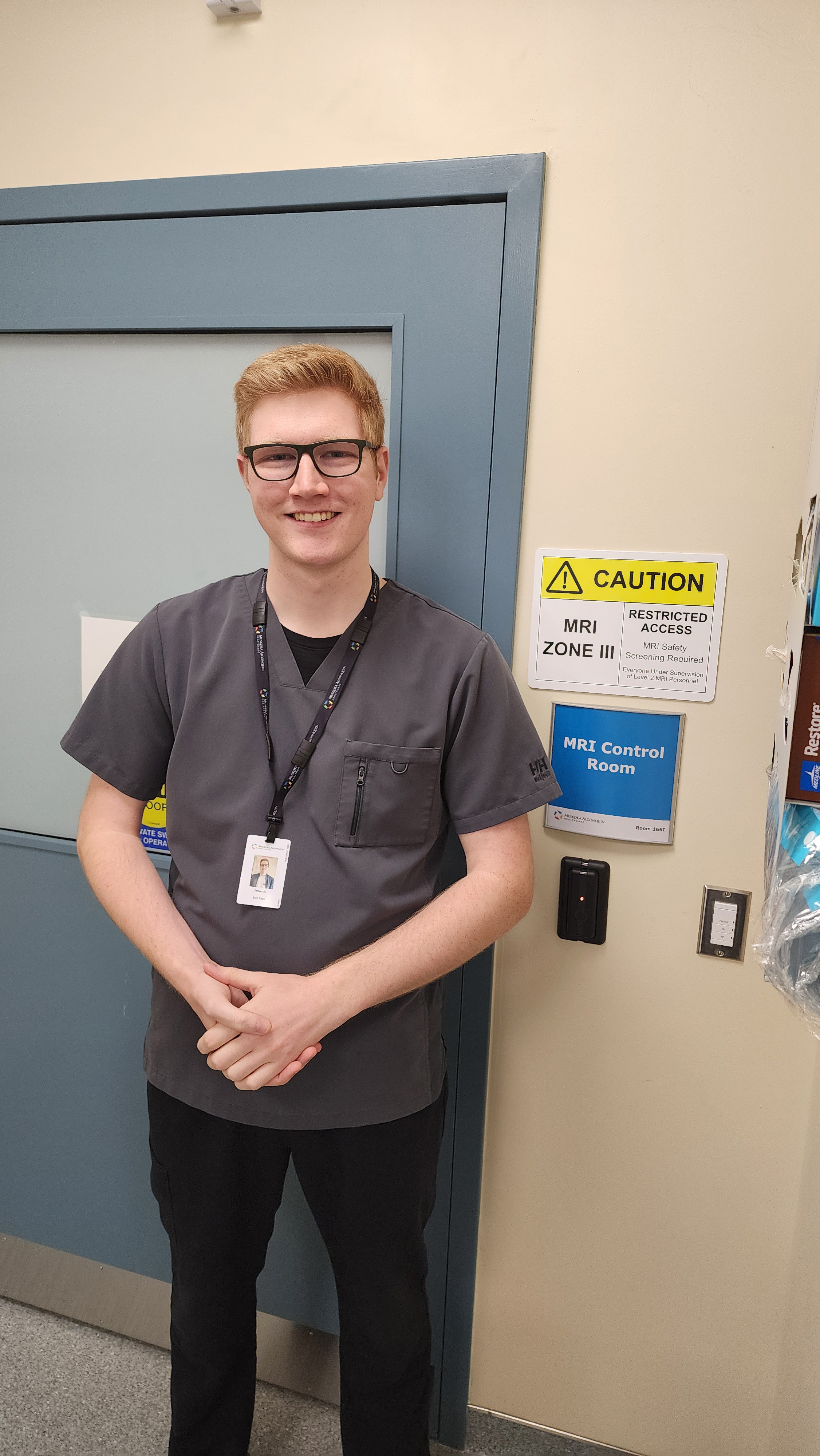Man standing beside MRI sign